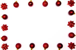 Top view photo christmas tree toys of red colour on white background for greeting card. Xmas backdrop with space for text.Copyspace.