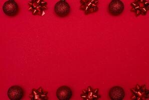 Top view photo christmas tree toys of red colour on white background for greeting card. Xmas backdrop with space for text.Copyspace.