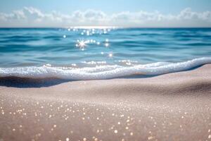 A sandy beach with waves and sun shining on it photo
