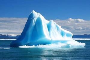 A large iceberg floating in the ocean photo