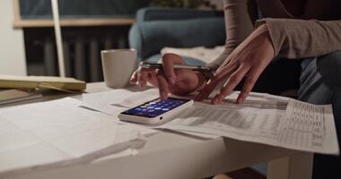 Cropped accountant using calculator app video