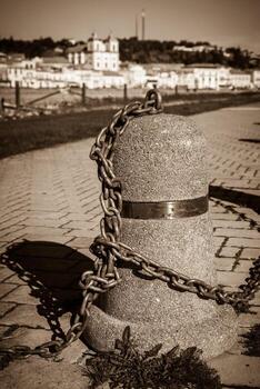 Stub posts linked in a chain on a quay photo