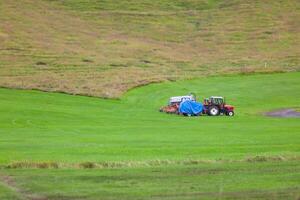Tractor with plowes on an Iceland field photo
