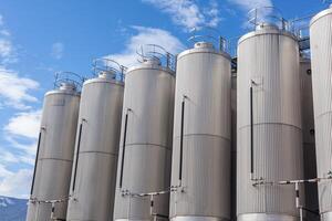 Giant industrial tanks on the bright blue sky photo