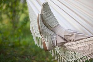 man in light suit in fabric hammock photo