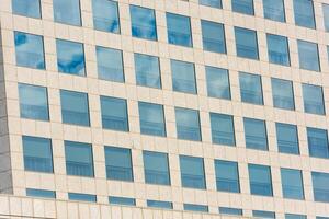 blue sky and clouds reflected in office building photo