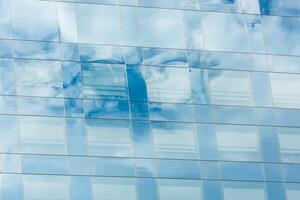 blue sky and clouds reflected in office building photo