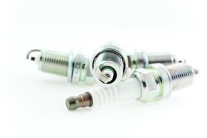 Four Spark Plugs on a white background photo