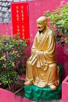 Golden statue in The monastery in Hong Kong photo