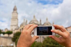 Tourist taking photo of Perigueux, France