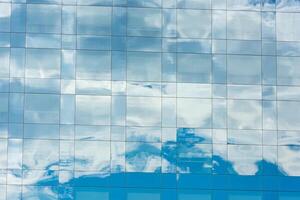 blue sky and clouds reflected in office building photo