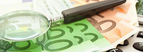 Euro Notes with calculator and magnifier photo