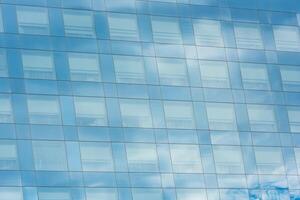 blue sky and clouds reflected in office building photo