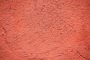 red colored plaster wall background photo