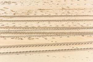 Traces of cars on the sand photo