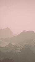 A misty mountain range under a cloudy sky video