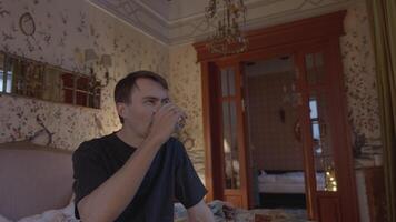 Man Drinks Water and Looks at the Camera video