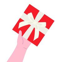 Hand holding red gift box with white ribbon and bow vector