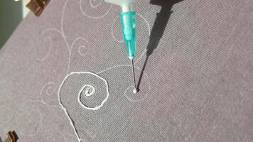 Intricate fabric design creation with precision needlework technique for embroidery and textile art. video