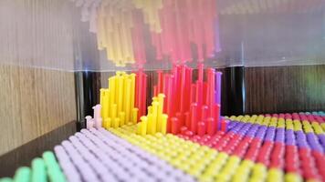 Colorful pin fidget wall with vibrant patterns creates dynamic and mesmerizing visual movements captured in high resolution. video