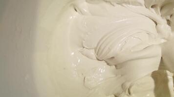Smooth mixing process of creamy batter in large bowl captured in high definition closeup sequence. video