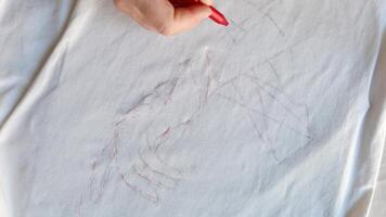 Hand writing artisanship captured in slow detail delicate red pen strokes create intricate geometric patterns on white canvas sheet. video