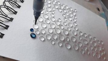 Creative process adding colorful dots to paper with precision in artistic pattern design. video
