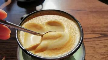 emocionante y levantamiento Café exprés espuma con cuchara capturar cremoso textura y suave remolinos en de cerca secuencia. video