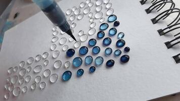 Creating a vibrant mosaic dropper technique on canvas demonstrating color transformation and arrangement in artistic design. video