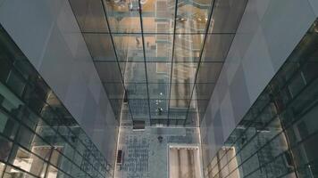 Aerial view of Windows in a high-rise office building early morning with entrepreneur enter building arrive start working. Corporate offices.Night view Skyscraper with night lights and empty offices video