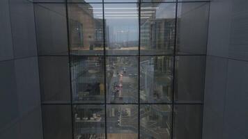 Aerial view of Windows in a high-rise office building early morning with entrepreneur enter building arrive start working. Corporate offices.Night view Skyscraper with night lights and empty offices video