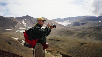 Man In Mountains, Traveler With Photo Camera Taking Pictures Of Fascinating Scenery In Highlands video