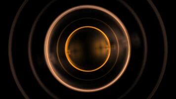 a black and gold circular object with a bright yellow light video