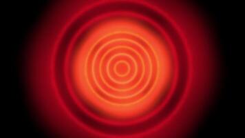 a red and black circular object with a black background video