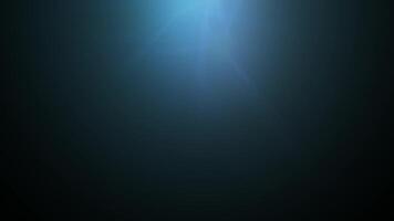 a dark background with a light shining through it video
