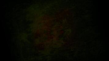 a dark green and red background with a red light video