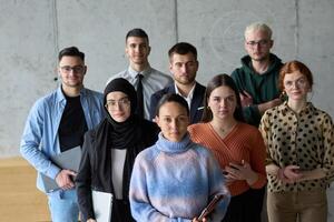 A diverse and determined team of business professionals stands confidently in an office, ready to tackle new business plans and challenges with a focus on success and growth photo