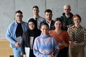 A diverse and determined team of business professionals stands confidently in an office, ready to tackle new business plans and challenges with a focus on success and growth photo