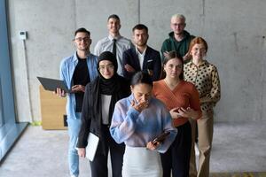 A diverse and determined team of business professionals stands confidently in an office, ready to tackle new business plans and challenges with a focus on success and growth photo