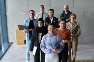 A diverse and determined team of business professionals stands confidently in an office, ready to tackle new business plans and challenges with a focus on success and growth photo