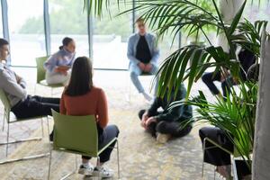 Corporate business team meeting with a manager or coach. Group of happy diverse, multiracial people sitting in a circle photo