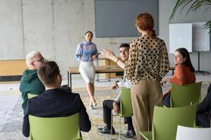 A diverse group of business professionals sits attentively in a modern office, actively participating in a training session led by an instructor, focusing on the latest technological advancements in photo