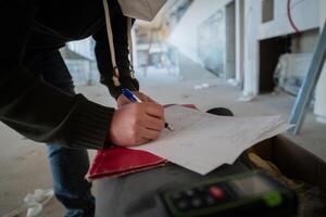 A close-up of an engineer's hand meticulously sketching an architectural project, capturing the precision, creativity, and focus involved in bringing innovative designs to life photo