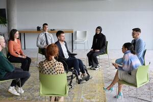 Corporate business team meeting with a manager or coach. Group of happy diverse, multiracial people sitting in a circle photo