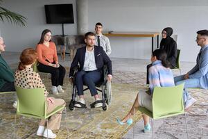 Corporate business team meeting with a manager or coach. Group of happy diverse, multiracial people sitting in a circle photo