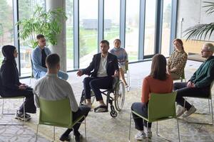 Corporate business team meeting with a manager or coach. Group of happy diverse, multiracial people sitting in a circle photo