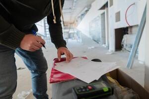 A close-up of an engineer's hand meticulously sketching an architectural project, capturing the precision, creativity, and focus involved in bringing innovative designs to life photo