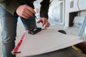 A close-up of an engineer's hand meticulously sketching an architectural project, capturing the precision, creativity, and focus involved in bringing innovative designs to life photo