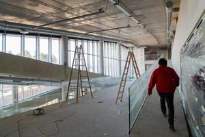 An engineer walks through the construction site, carefully inspecting the ongoing work to ensure quality control and progress in the project photo