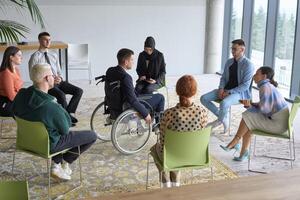 Corporate business team meeting with a manager or coach. Group of happy diverse, multiracial people sitting in a circle photo